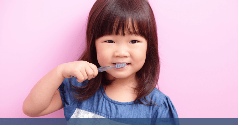 Little girl brushes her teeth after a back-to-school dental check up!