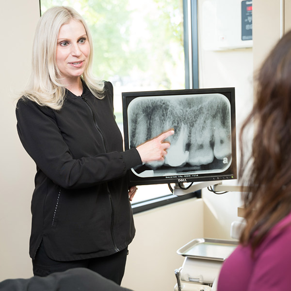 Harmony Dental staff explaining an x-ray to a patient